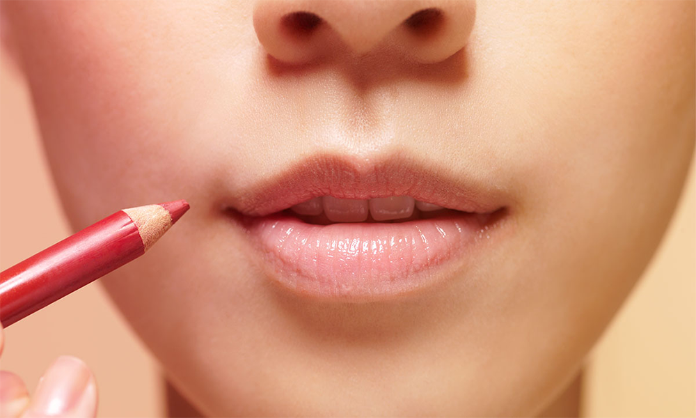 A collection of lip liners shades displayed on a chic marble surface.